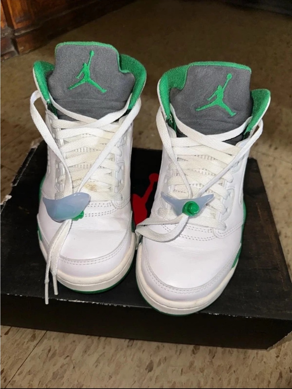 Jordan women’s White and Green High-Top Sneakers